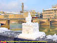 A curius snow puppet in the shape of Palazzo Vecchio built along the Arno river in Florence.